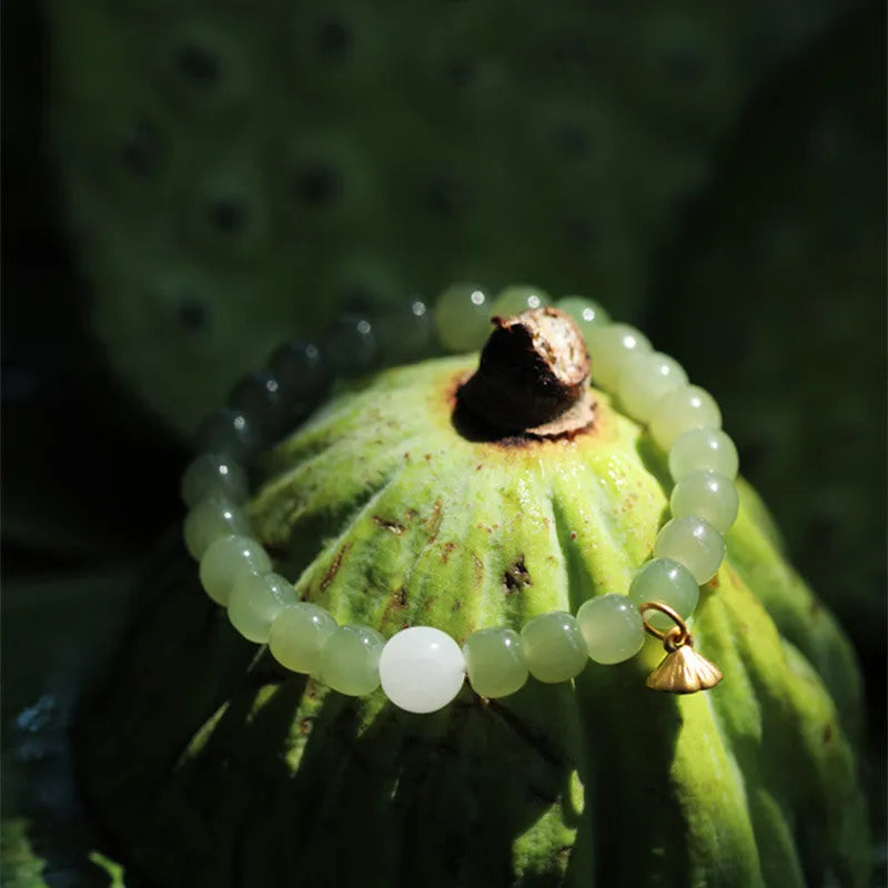 Green Hetian jade bracelet with vintage beads for women in an ethnic style.