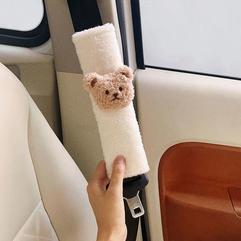 Cartoon bear design plush car seat belt protective cover for infant safety, showing khaki and coffee colour options