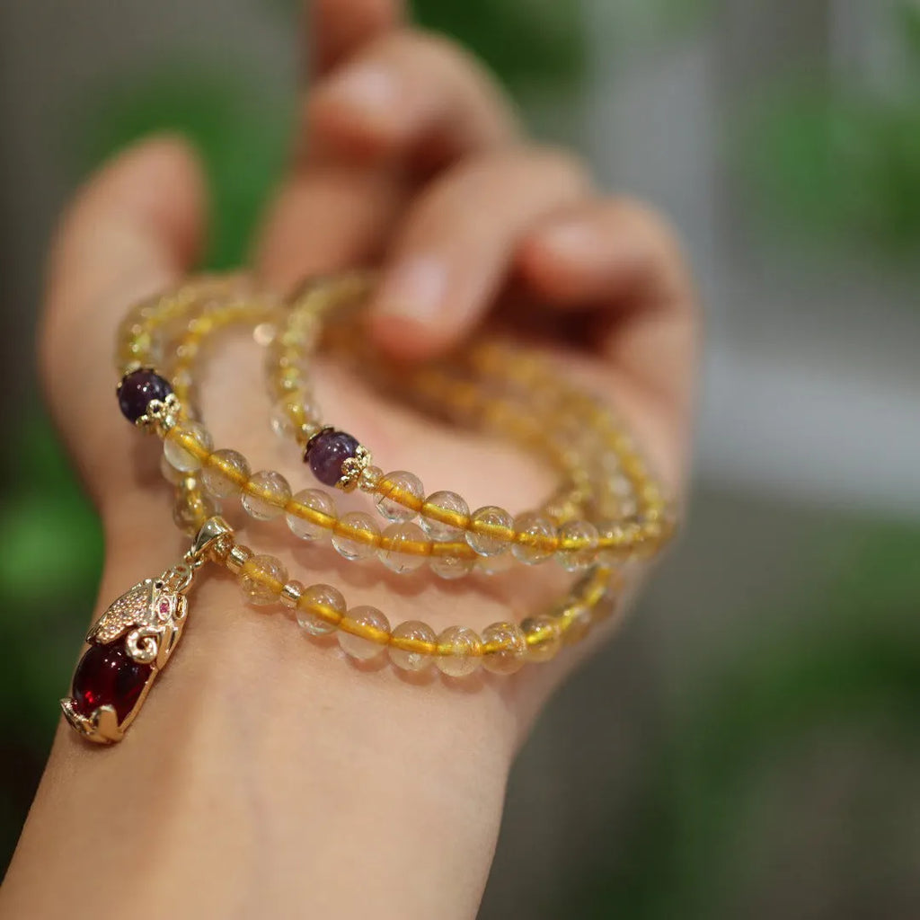 Natural Brazil gold rutilated quartz bracelet with three gold circles and ruby accents in Chinese-style design