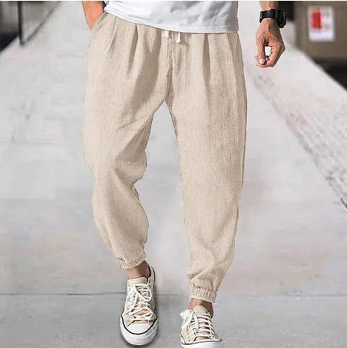 Man wearing loose light-coloured cotton trousers with a banded ankle cuff