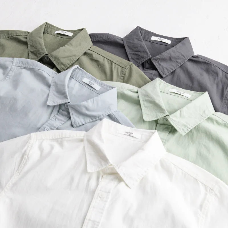 Men's light blue loose-fit short sleeve cotton shirt on a hanger.