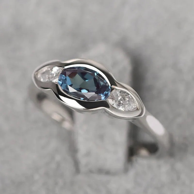 Geometric ellipse copper ring with zircon inlay, white gold colour finish, shown in size options 6-10