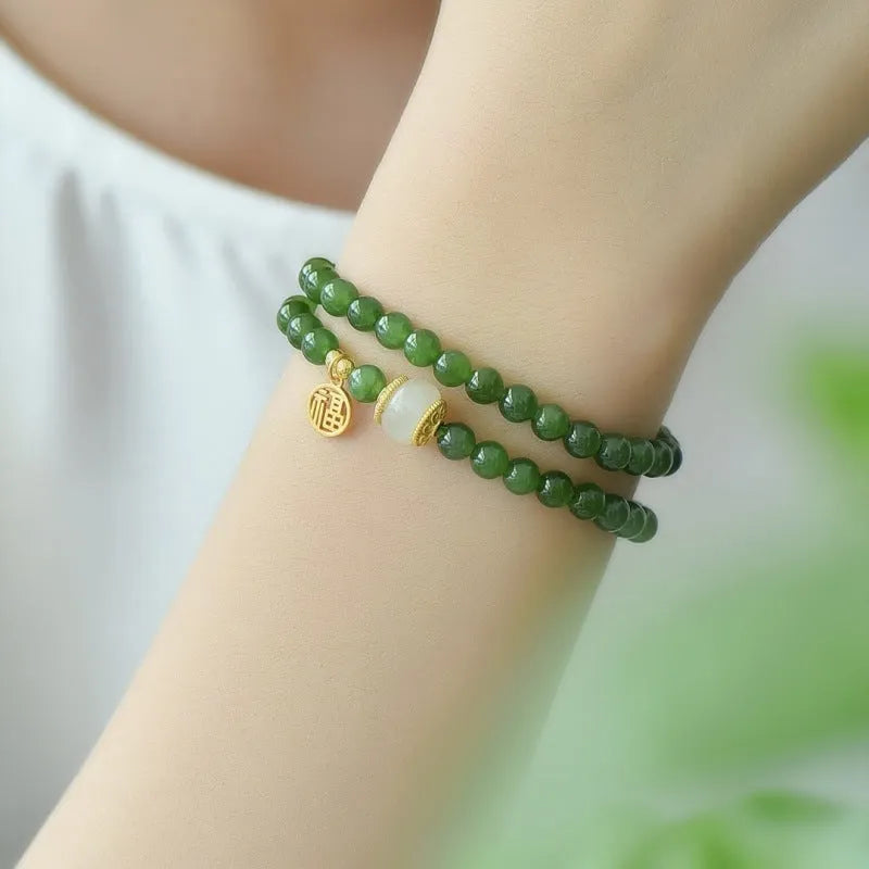 Women's double circle bracelet with natural Hetian jade beads and a central fu character charm.