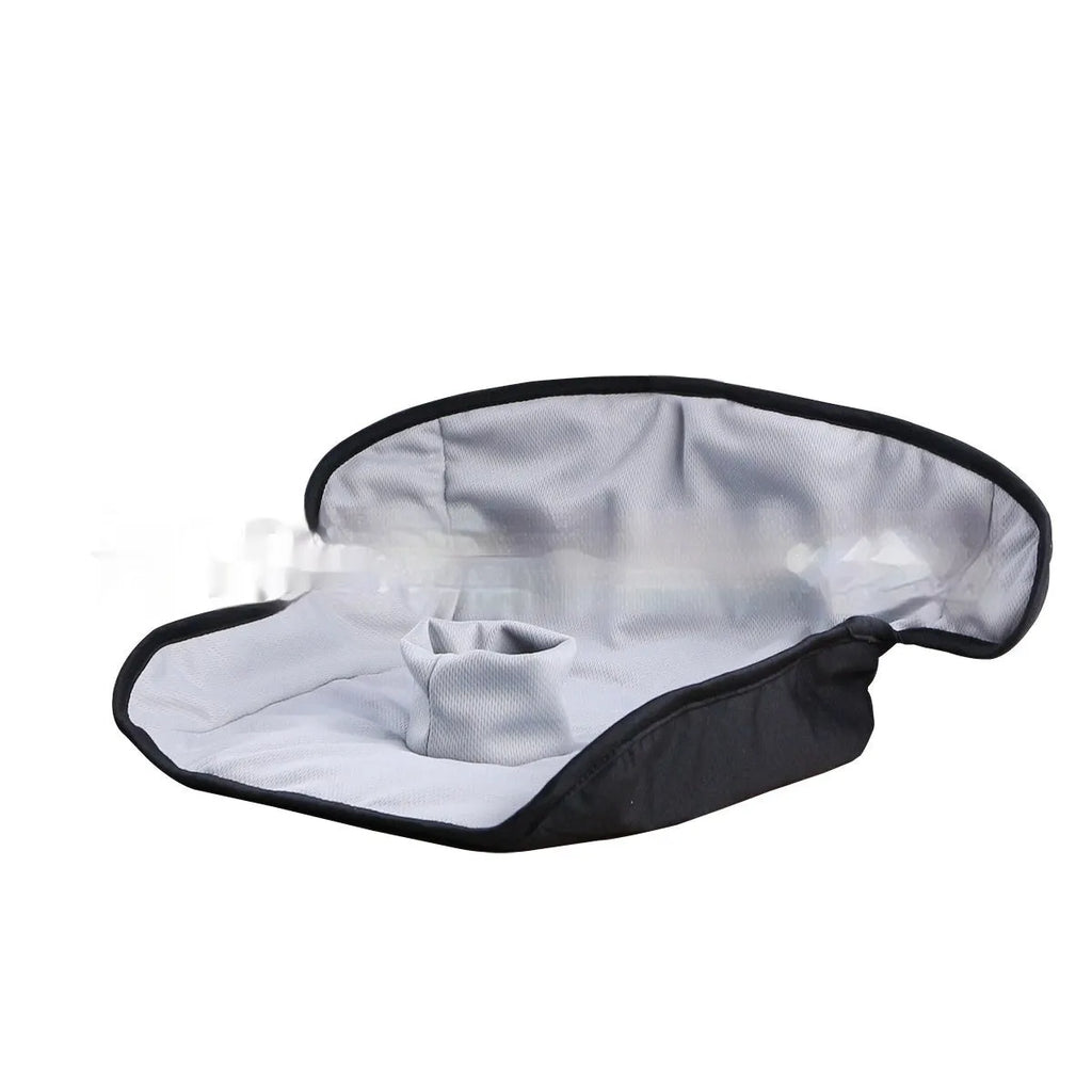 Alien-shaped grey car seat protective pad with urine-separation layer on a car seat.