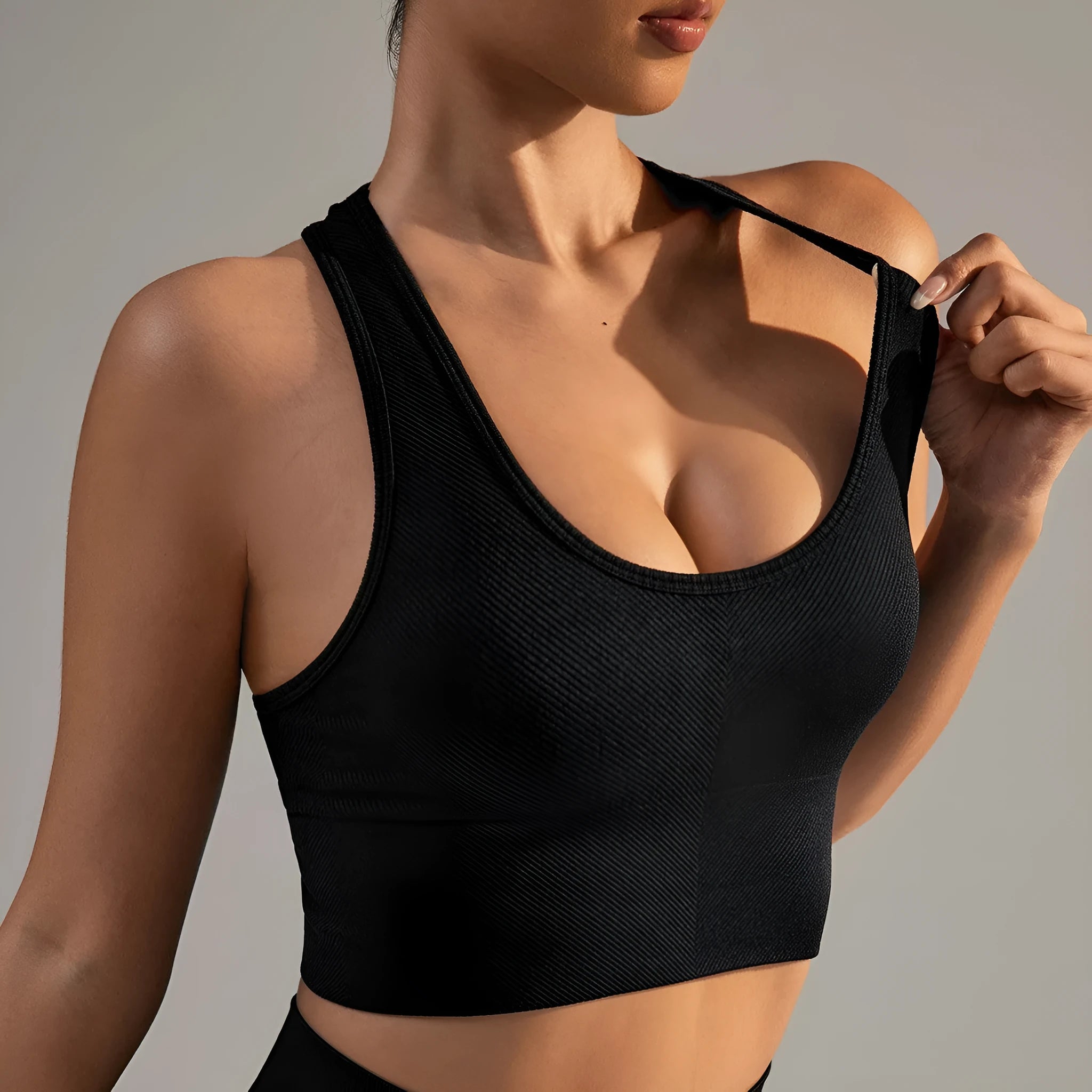 Black women's cross back sports bra with fixed double straps and molded cups.