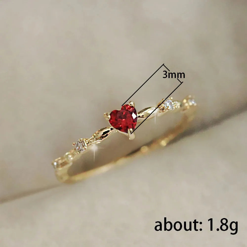 Gold and silver electroplated peach heart ring with zircon stones on a copper base.