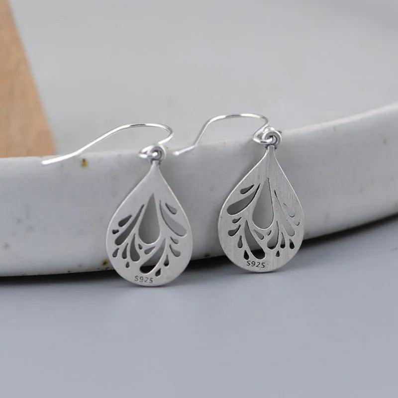 Pair of silver retro hollow water drop earrings with a hand-ground finish.