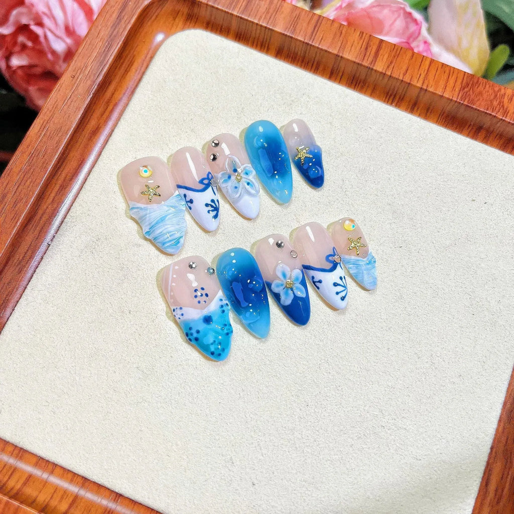 Blue hand-painted carved fake nails with summer ice patterns, transparent sections showing natural nails, four size options displayed
