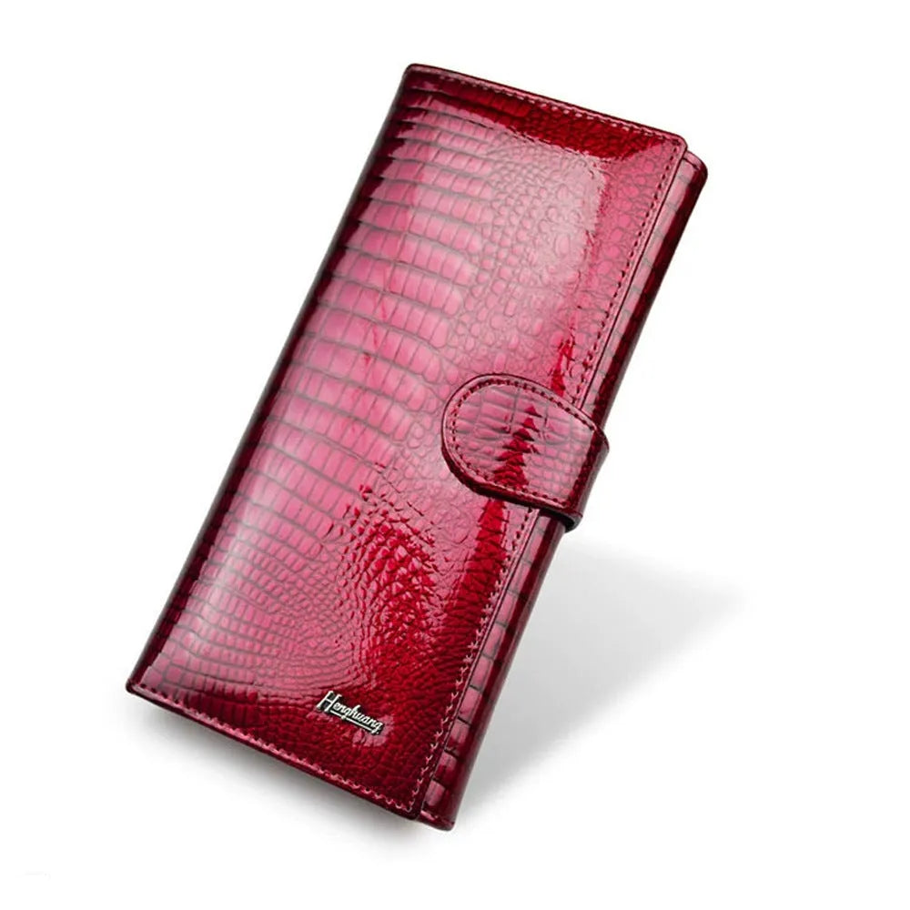 Women's leather purse with crocodile pattern design in wine red colour showing interior pigskin lining