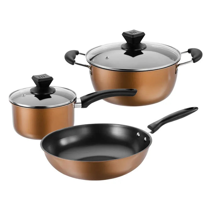 Cast iron three-piece cookware set with soup pot, milk pot, and wok on a kitchen counter
