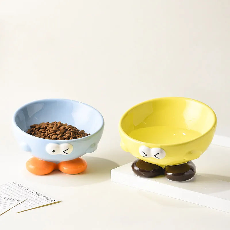 Blue slanted ceramic pet bowl for cats and dogs on a plain background.