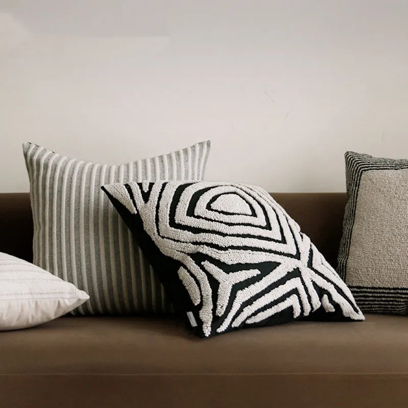 Black and white geometric patterned square and waist living room cushions with towel embroidery.