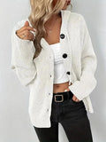 A thick grey cotton hooded cardigan sweater on a hanger, showing its single-breasted front and long sleeves.