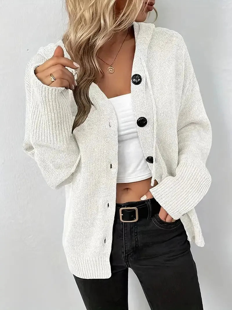 A thick grey cotton hooded cardigan sweater on a hanger, showing its single-breasted front and long sleeves.