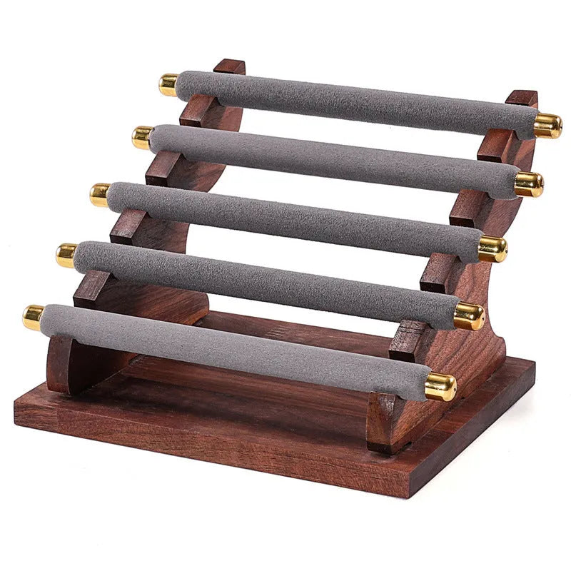 Solid wood trapezoid ring display stand with multiple fabric-lined layers in walnut finish
