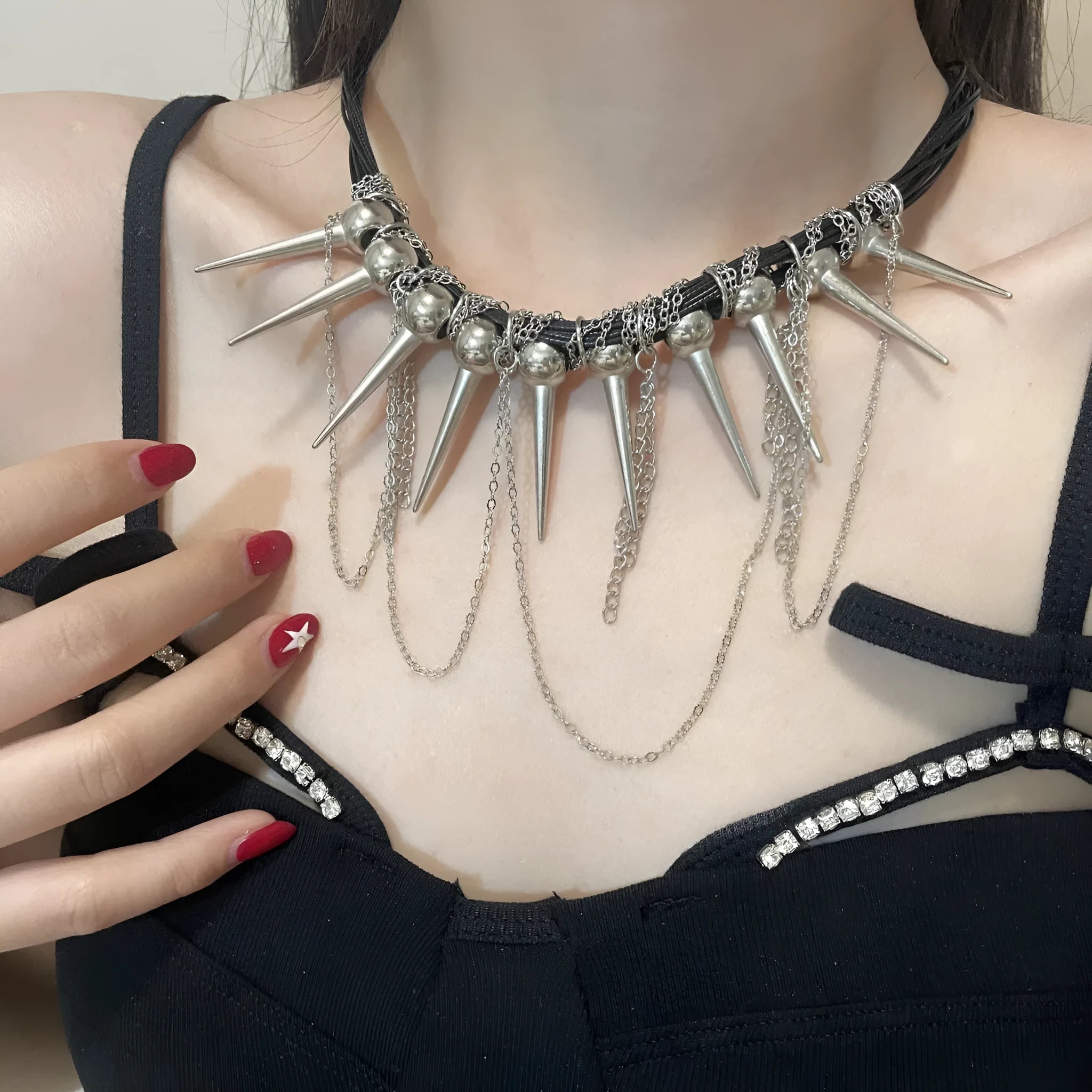 Leather necklace with winding tassel, round beads, and metallic rivet details in a picture colour.