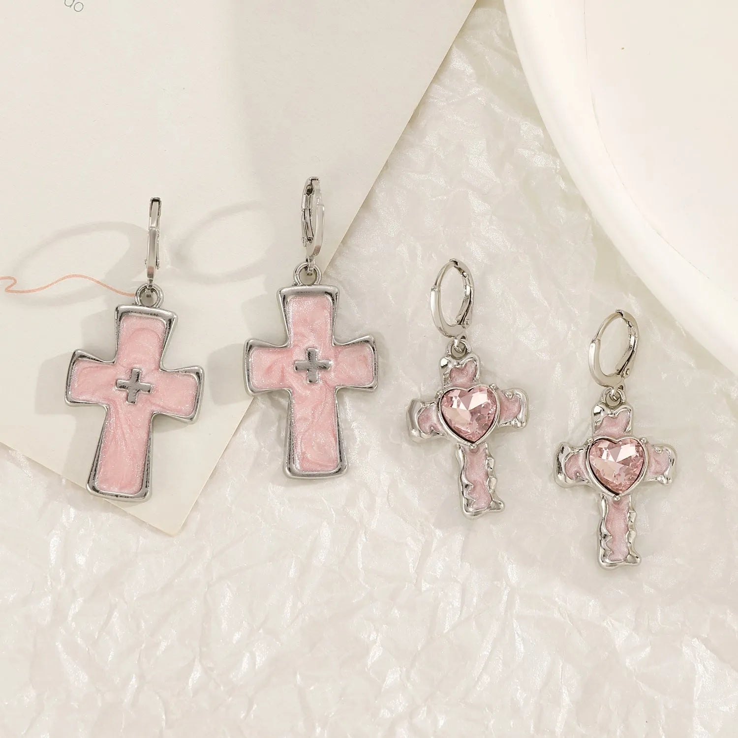 Women's alloy earrings with dripping oil treatment in five colour options showing cross and heart designs