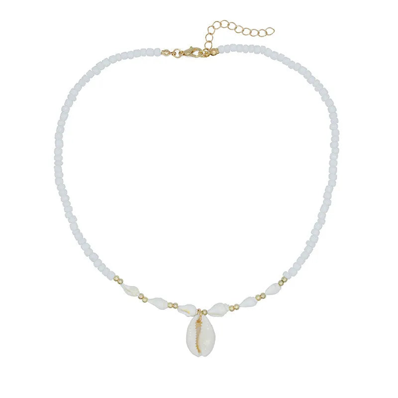 White shell necklace with conch-shaped pendant on adjustable chain, showing mother-of-pearl texture.