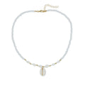 White shell necklace with conch-shaped pendant on adjustable chain, showing mother-of-pearl texture.