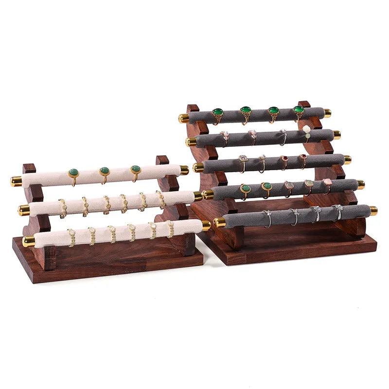 Solid wood trapezoid ring display stand with multiple fabric-lined layers in walnut finish
