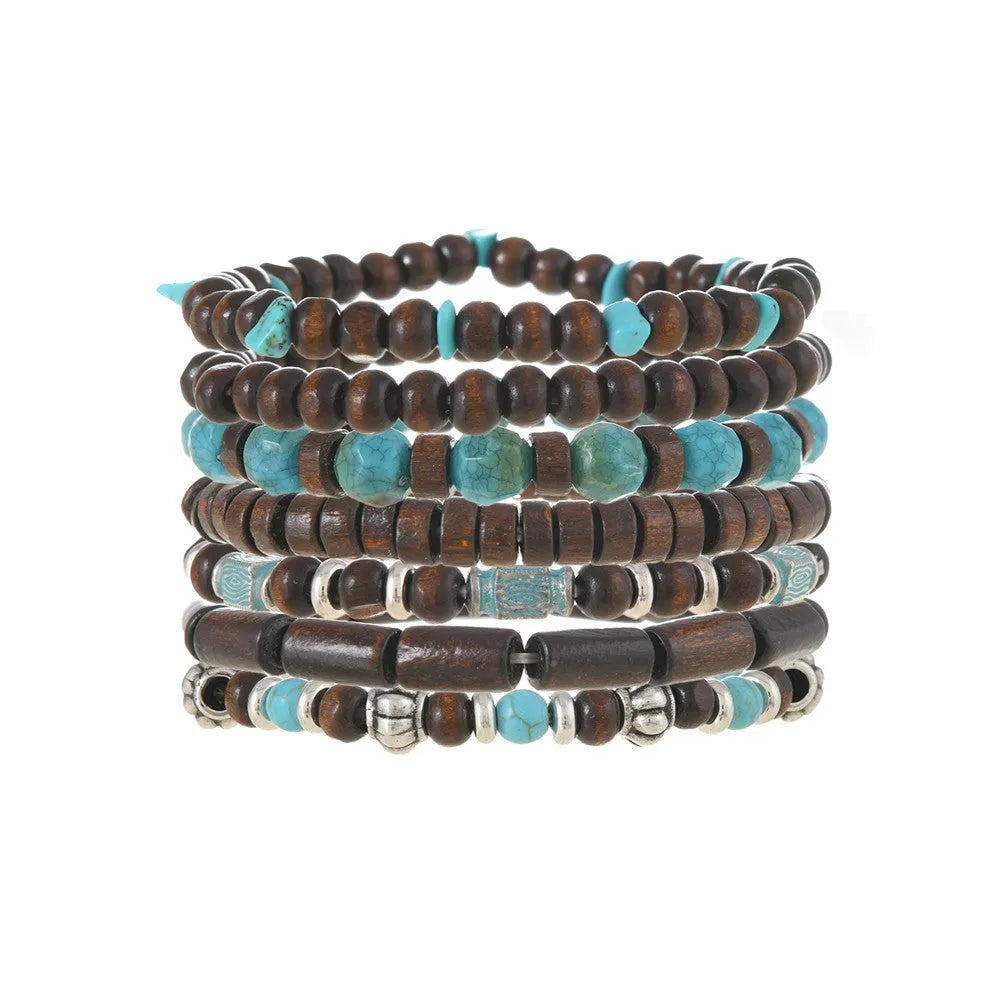 Seven multicolour retro bracelets with round wooden beads and alloy details laid out flat.