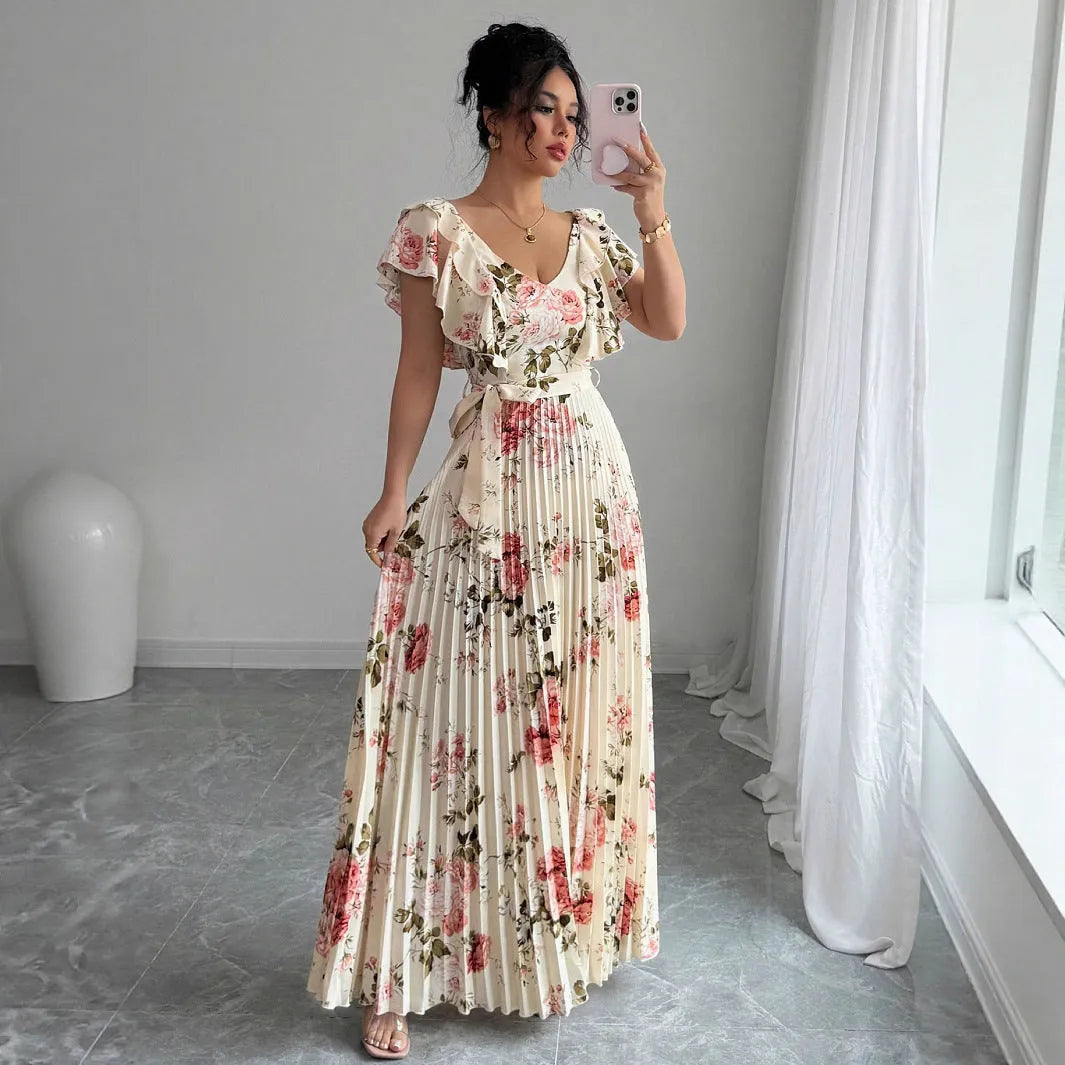 V-neck floral print dress with oversized swing skirt and ruffled sleeves in apricot colour, showing high waist and pleated details