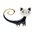 Close-up of a white alloy brooch with a painted tail-up kitten design.