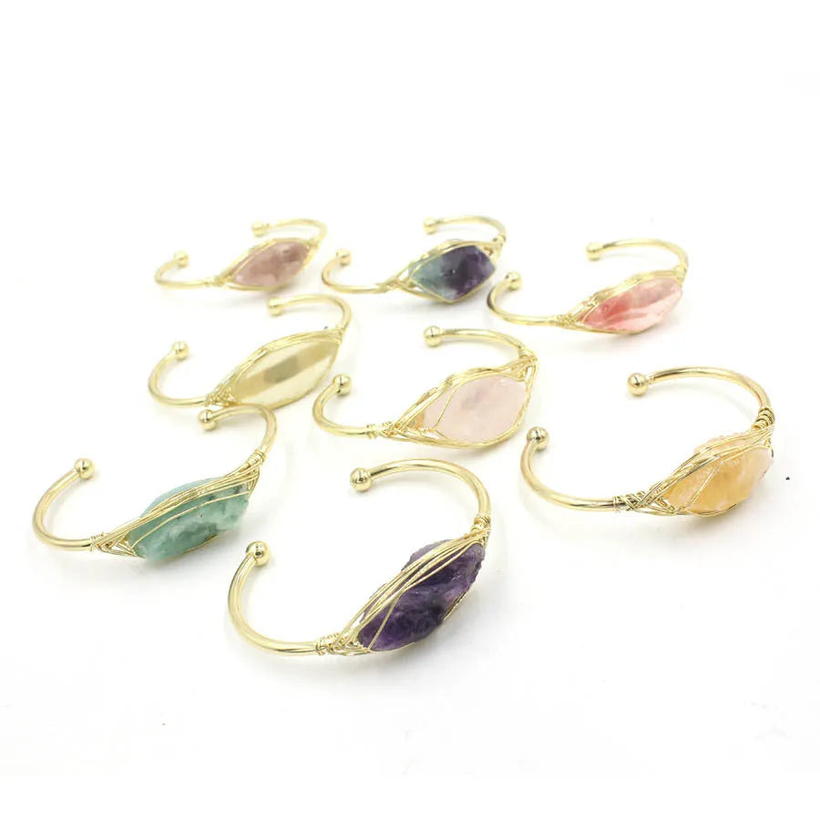 Natural raw gemstone bracelet with 8mm amorphous crystals in various colours on a wrist, showing ethnic style and simple clasp.