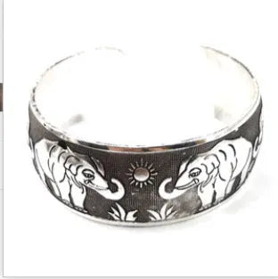 Ethnic style Miao silver bracelet with open carved design in Roman shape, showing diamond treatment surface detail