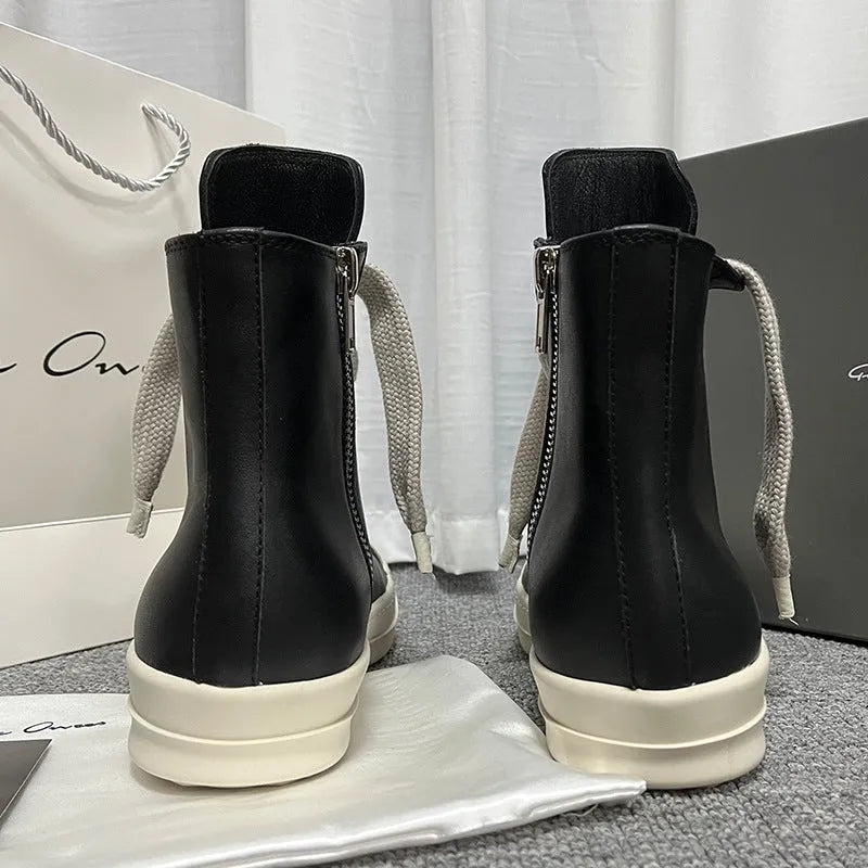 High-top leather sneakers with side zipper in black, showing platform heel and stitching details