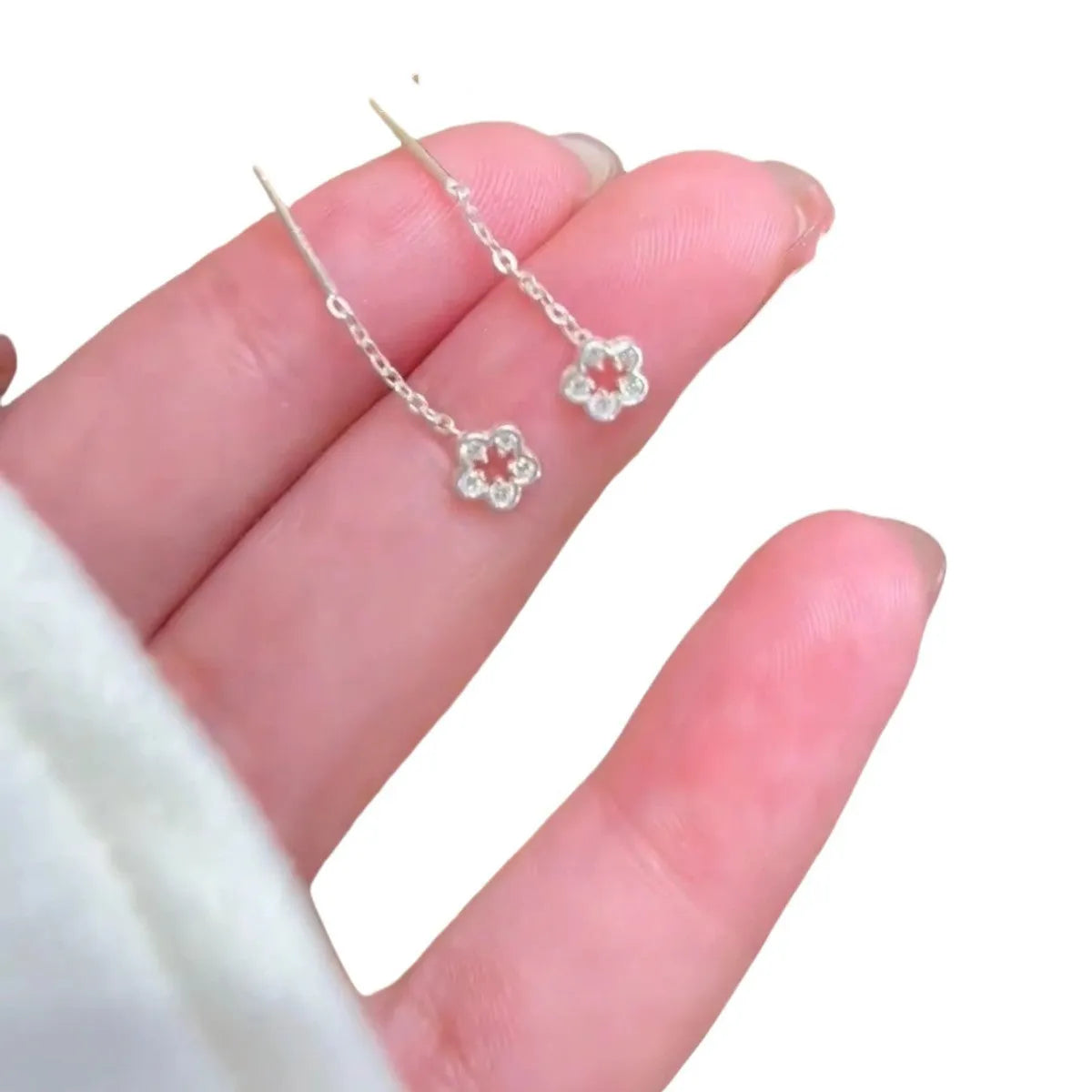 Silver hollow flower stud earrings with natural petal design on alloy backing