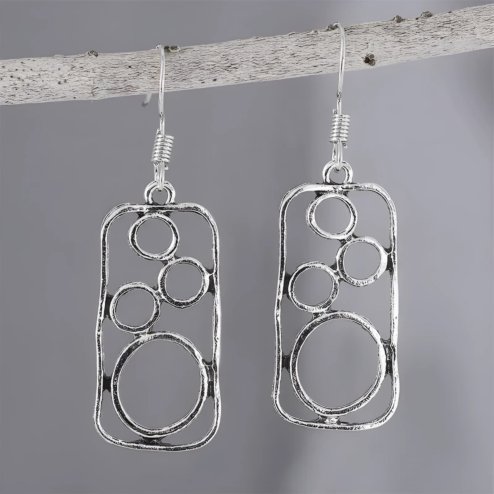 Pair of antique silver geometric earrings with an irregular square stud and round ring on zinc alloy posts.