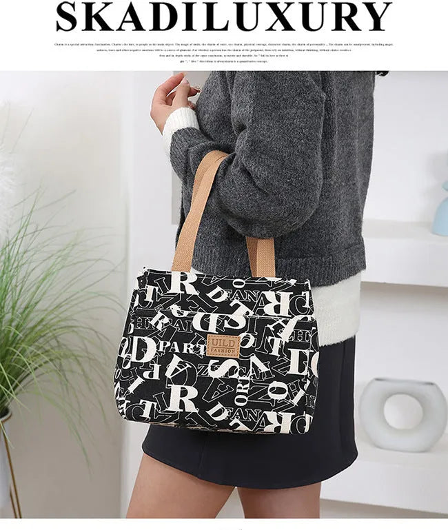 Women's portable printed canvas handbag with floral or animal motifs, aluminium hardware, and horizontal square shape
