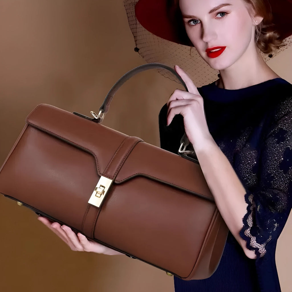 Women's cylindrical cowhide leather messenger bag in black or caramel colour with retro styling