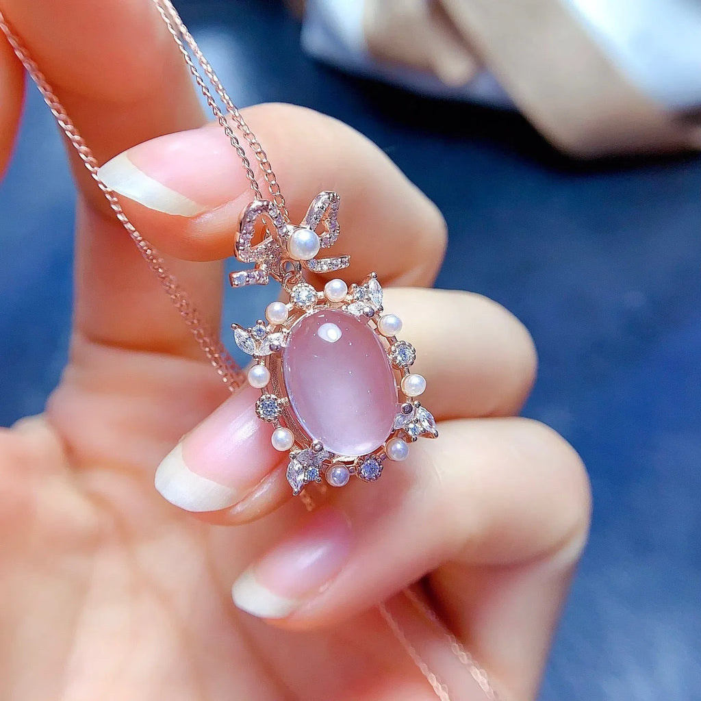 Geometric silver pendant with pink rose quartz crystal and rose gold plating on necklace chain