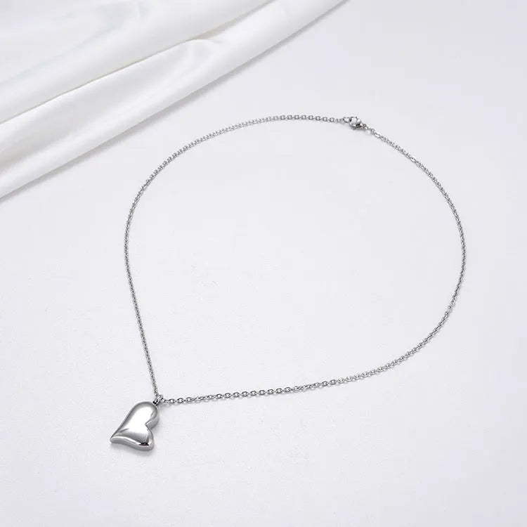 Silver curved peach heart pendant on adjustable stainless steel necklace, 51cm chain with 5cm extension