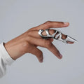 Silver alloy punk armour finger stall with textured ridges on a hand