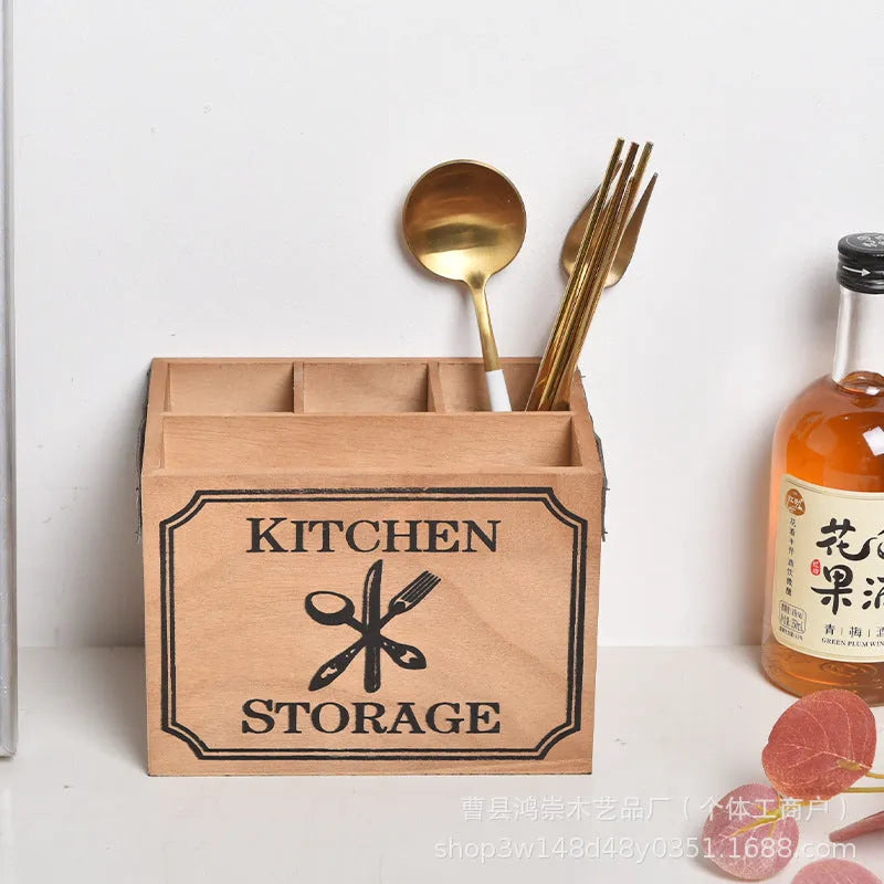 Wooden kitchen storage box with internal grid divider for organising knives, forks, and chopsticks.