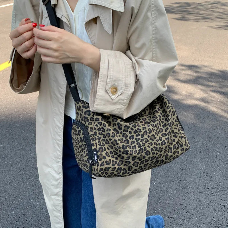 Unisex leopard print messenger bag with striped pattern, crossbody shoulder design