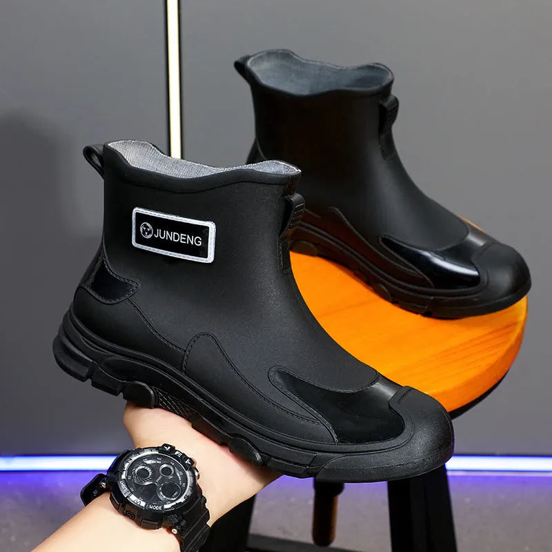 A pair of minimalist Korean-style PVC waterproof boots for adults with a non-slip sole.