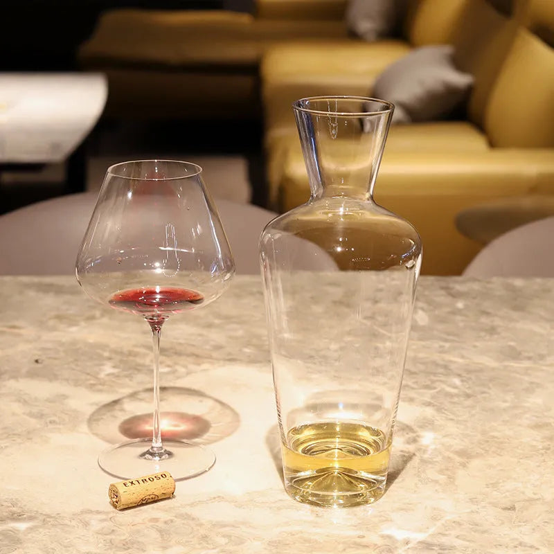 Clear glass wine decanter with removable interior divider shown on a table