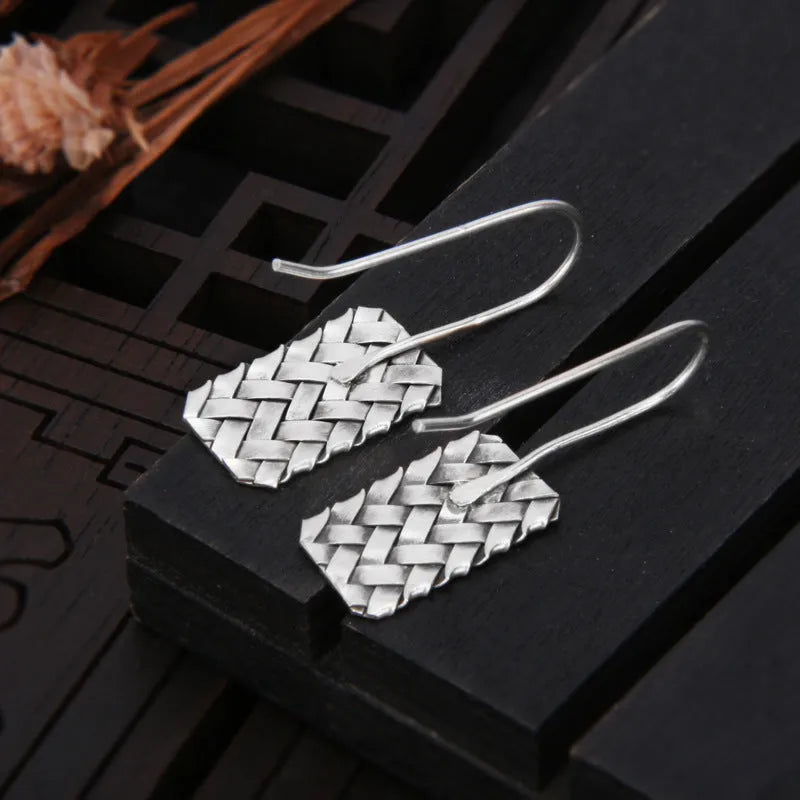 Silver geometric earrings with woven diamond plaid pattern, measuring 17.5mm by 11mm