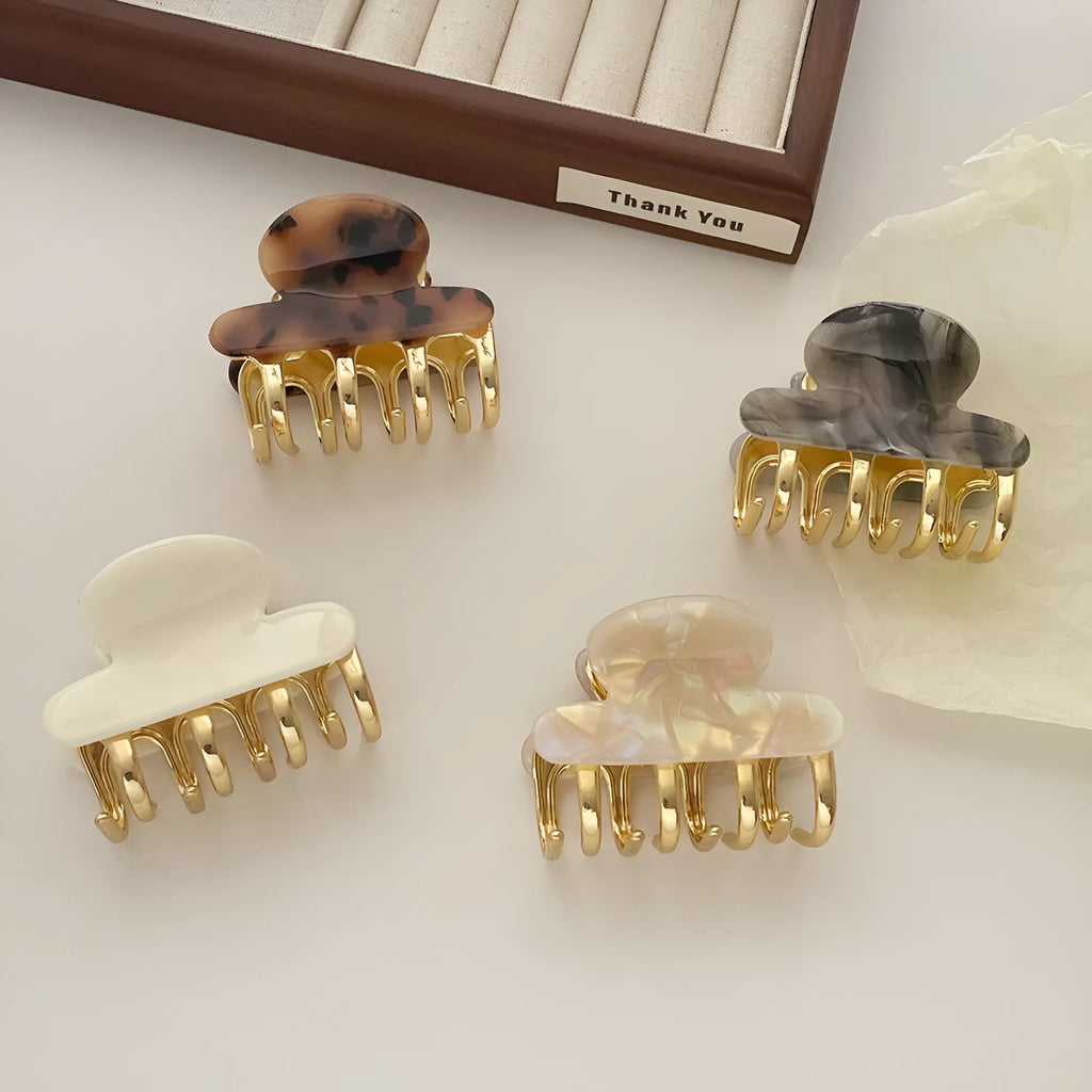Set of retro-style alloy acrylic women's hair barrettes with metal grip in beige, white, ink and leopard print colours.