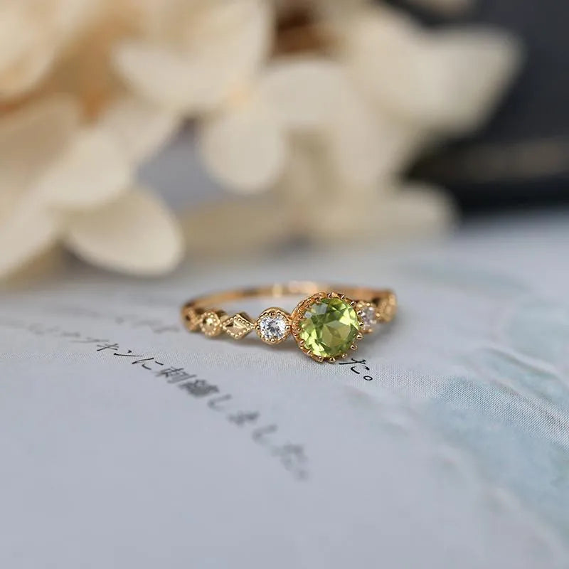Quadrilateral geometric copper ring with imitation peridot stone, showing angular design and metallic finish