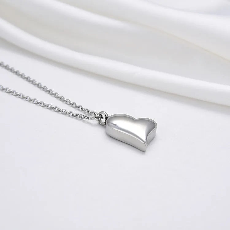 Silver curved peach heart pendant on adjustable stainless steel necklace, 51cm chain with 5cm extension