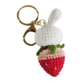 White hand-woven rabbit strawberry pendant with cartoon design and attached key on four-strand doll wire