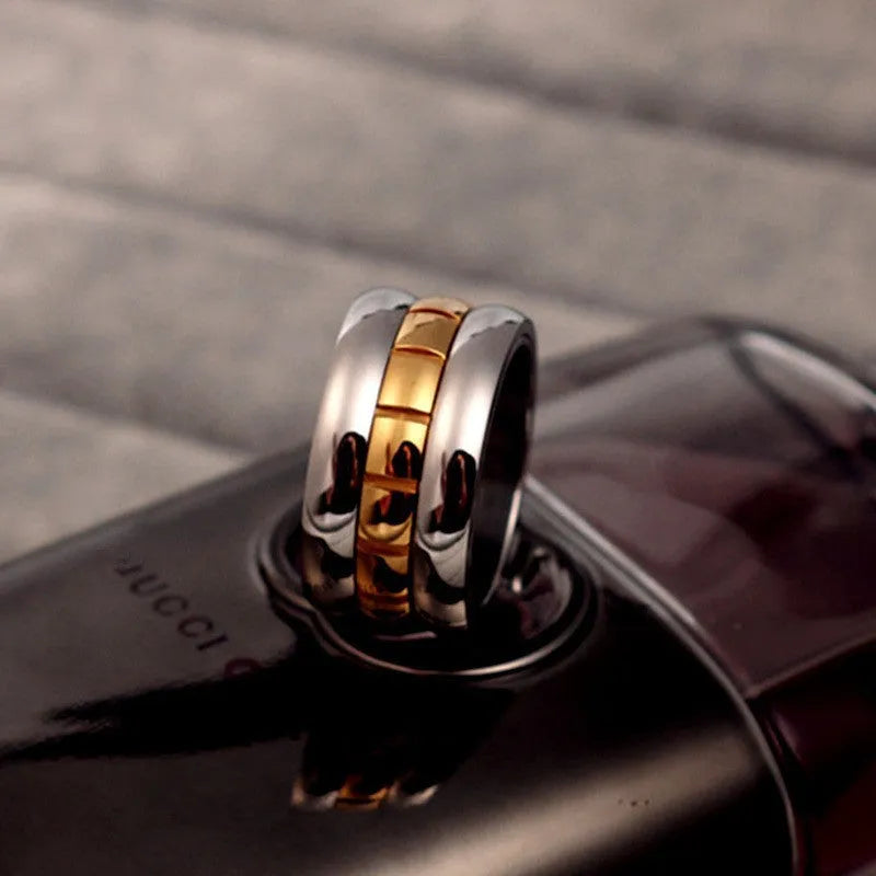 Gold titanium steel ring with rotating ultra-wide knuckle section shown in multiple size options