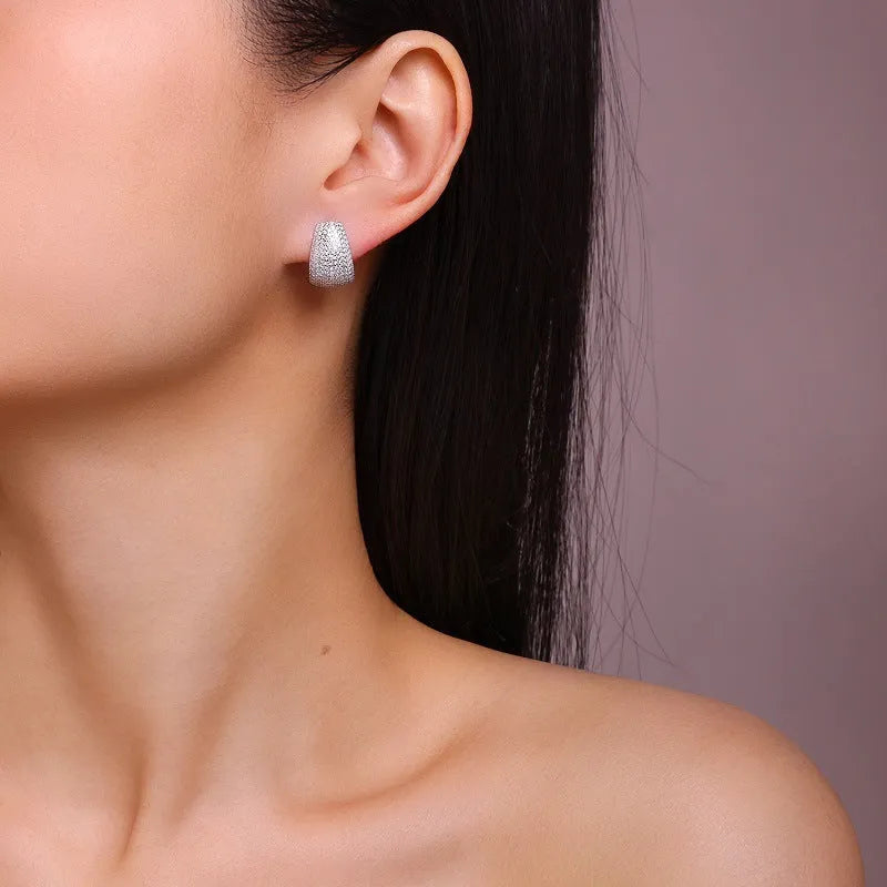 Geometric silver stud earrings with moissanite stones showing front and back views