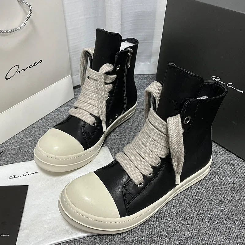 High-top leather sneakers with side zipper in black, showing platform heel and stitching details