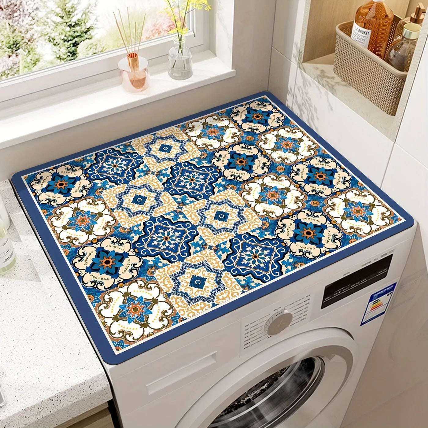 Square polyester washing machine floor mat with an abstract printed design in front of a laundry appliance.